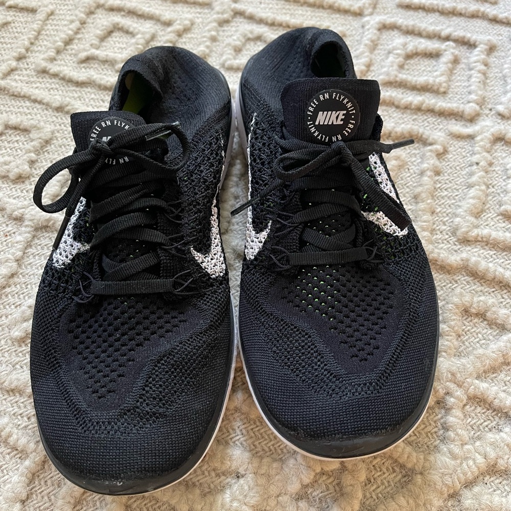 Black Nike running shoes, size 9